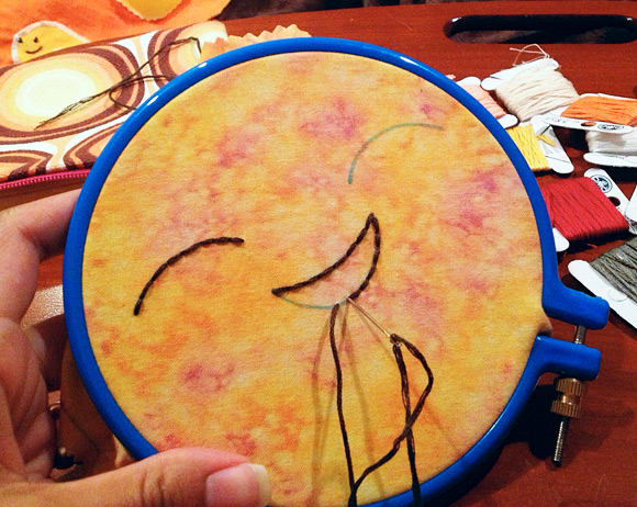 Embroidering a cheerful face on Venus.